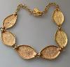 Yves Saint Laurent gold metal necklace with diamond-streaked shuttle links, vintage, very good condition